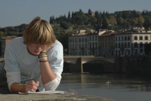 Student reading on bridge